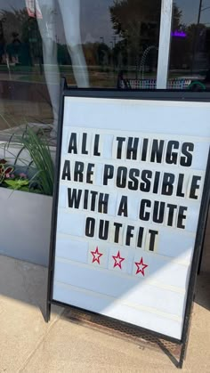 a sign in front of a store that says all things are possible with a cute outfit