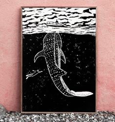 a black and white drawing of a whale swimming in the ocean next to a pink wall