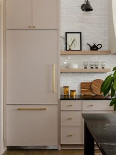 a white refrigerator freezer sitting inside of a kitchen next to a wooden counter top