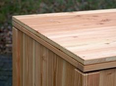 a wooden box sitting on top of a sidewalk