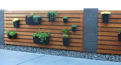 a wooden fence with plants growing on it