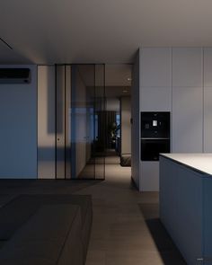 an empty kitchen and living room are seen in this image from the hallway to the bedroom