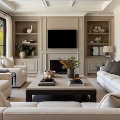 a living room filled with furniture and a flat screen tv mounted on the wall above a fireplace