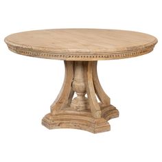 a round wooden table sitting on top of a white floor