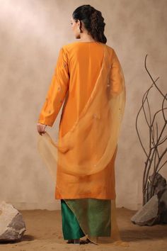 Mustard straight kurta with floral embroidery. Comes with contrast pant and dupatta.
Components: 3
Pattern: Embroidered
Type Of Work: Sequins, Pearls, Cutdana
Neckline: Round
Sleeve Type: Full
Fabric: Kurta and Pant: Chanderi, Dupatta: Organza
Color: Orange
Other Details: 
Attached lining
Approximate product weight: 0.5-1 kg
Occasion: Puja - Aza Fashions Semi-stitched Raw Silk Palazzo Set, Raw Silk Palazzo Set With Zari Work, Dola Silk Palazzo Set With Dabka Work, Chanderi Sets With Embroidered Border For Diwali, Diwali Chanderi Sets With Embroidered Border, Diwali Embroidered Chanderi Sets, Silk Palazzo Set With Dupatta, Diwali Unstitched Slub Silk Suit, Festival Slub Silk Palazzo Set