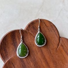 Stone Type: Nephrite Jade Metal: 925 Sterling Silver Earring Size (without hook): ~0.85 x 0.53 x0.25 in. Drop Length: ~1.35 in. Earring Weight: ~5.15 g NATURAL JADE: This is a high grade jade earring. The stone is completely natural nephrite jade. DESCRIPTION: The "Jade Teardrop Earrings" feature large, polished nephrite green cabochons in an elegant teardrop shape. Set in sleek sterling silver, the vibrant green stones are securely framed, highlighting their natural beauty. These lightweight, comfortable earrings dangle gracefully, perfect for both everyday wear and special occasions. JADE COLOR: Green. Note: Jade is a natural stone, so each piece will have slight variations in color and texture, but will closely resemble the listing photos. GIFT READY: Comes with a gift box. Perfect for Green Stones, Nephrite Jade, Jade Earrings, Metal Shop, Earrings Green, Natural Jade, Vibrant Green, Silver Earring, Green Stone