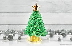 a small green christmas tree sitting on top of a table