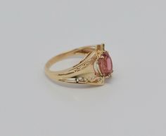 This is a 10K Yellow Gold Pink Tourmaline Ring, 5.8x8mm faceted stone center, bright pink, pierced decorated top, .5 inch across, Circa 1990, Ring size 7, weight 3.5 grams Stock # BB104R29 This listing contains photographs of the actual item you will receive. Our items are in excellent condition with little or no signs of wear and many are one of a kind pre-owned estate finds. Please look closely at the pictures in this listing as they are part of the product description. Please read the descrip Formal Fine Jewelry Tourmaline Birthstone Ring, Tourmaline Birthstone Ring, Fine Jewelry For Formal Events, Tourmaline Birthstone Ring For Formal Occasions, Formal Pink Oval Birthstone Ring, Gold Coin Ring, Pink Tourmaline Ring, Coin Ring, Tourmaline Ring, Fine Jewelry Designers