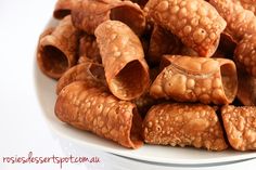 a white plate topped with croissants covered in sauce