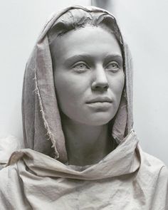 a black and white photo of a woman wearing a hood