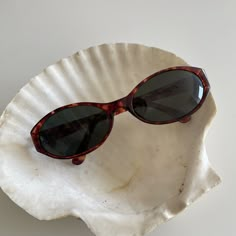 These round oval sunglasses are your everyday classic. Featuring a red tortoise frame with black smoke lens. This style is unisex. True genuine vintage sunglasses from the 90s.  - 400 uv  - new vintage from the 90s - includes sunglasses pouch  Measurements: Lens width 58mm Lens height 34mm Frame width 133mm Bridge 17mm Arm temple 130mm Available in other colors Black https://etsy.me/3CNzctd Amber red https://etsy.me/3FIQCZU Cheap Vintage Sunglasses For Women, Cheap Retro Glass Sunglasses, Affordable Retro Oval Sunglasses, French Connection Sunglasses Tortoise Shell, Cheap Trendy Oval Sunglasses, Cheap Retro Sunglasses For Spring, Cheap Vintage Brown Sunglasses, Vintage Sunglasses Aesthetic, 90s Sunglasses Vintage