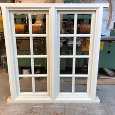 two windows sitting next to each other in front of a machine tool shop window sill