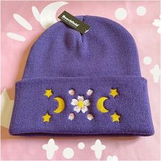 This super cute purple beanie features a machine embroidered appliqué featuring sakura flowers, petals, crescent moons and stars. They are made with the Beechfield purple beanie. We also have a pink variation available! Purple Sakura, Purple Gifts, Pastel Witch, Purple Beanie, Embroidered Beanie, Fast Fashion Brands, Purple Gift, Pink Beanies, Kawaii Gifts