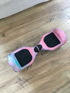 a pink and black hover sitting on top of a wooden floor