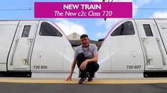 a man kneeling down in front of a train with the words new train on it