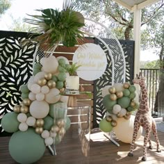 a giraffe is standing next to some balloons