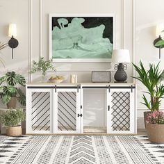 a living room scene with focus on the sideboard and potted plants in vases