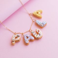 The Perfect Daughter Gift from Mom, Name Necklace For Girls, Name Jewelry For Kids, Children Name Necklace, Kid Name Necklace Personalize your donut necklace with either your name or your nickname! With this donut necklace. Each donut letter is handmade in air-dry clay, it is strong, durable, and does not cause allergies. The 14K gold plated and Sterling Silver 925 chain is 15.74 inches (40 cm) long and is perfect for children or adults.  The decoration is randomly arranged in pastel colors maki Donut Necklace, Cupcake Necklace, Name Choker, Tooth Charm, Jewelry For Kids, Necklace For Girls, Gold Flake, Herringbone Design, Gold Name Necklace