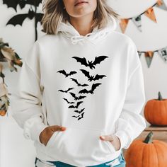 Flying Bats Hoodie, Halloween Bats Hoodie, Spooky Season Hoodie, Fall Hoodie, Halloween Hoodie, Ghost Shirt, Halloween Season, Halloween HOW TO ORDER 1-) Please, check and review all photos 2-) Choose your item size and color. If you would like to order a color that is not available in the options, please contact us. 3-) Click add to cart. You can go back to add more product 4-)Click "Proceed to check out" 5-)When you check out, you can add a note to seller for any request PRODUCT FEATURE It's a 50% Cotton /50% polyester, 13.5oz fleece. It features a double-needle collar, shoulders, and armholes. It also features double-needle cuffs, a banded bottom, set-in sleeves and a quarter-turned body and 1X1 Athletic rib with Lycra®. WASHING INSTRUCTIONS Wash inside out in cold water on a gentle cyc White Long Sleeve Hoodie For Halloween, Spooky Long Sleeve Winter Hoodie, Spooky Hooded Sweatshirt For Winter, White Long Sleeve Halloween Hoodie, White Halloween Hoodie Long Sleeve, Spooky Hooded Sweatshirt For Fall, Halloween Cotton Sweatshirt With Drawstring Hood, White Halloween Hoodie, Halloween Hooded Loungewear Hoodie