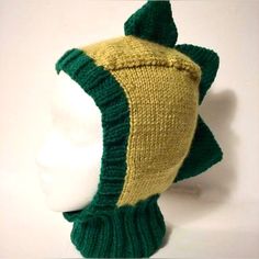 a knitted green and yellow hat on top of a white mannequin head