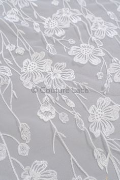 white lace with flowers and leaves on grey fabric, suitable for wedding dress or bridal gown