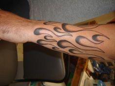 a man's arm with flames on it