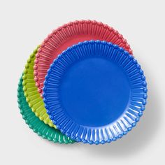 three different colored paper plates stacked on top of each other