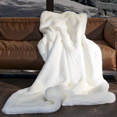 a white blanket sitting on top of a couch