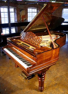 a grand piano sitting in the middle of a room