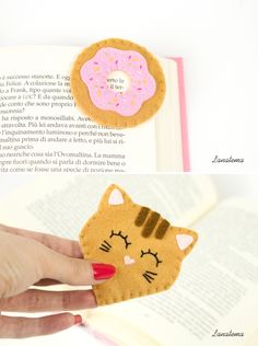 two pictures of an open book with a cat and donut on it