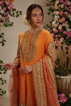 Peach orange georgette long anarkali with intricate gota work in floral pattern. Comes with matching salwar and pure organza dupatta.
Components: 3
Pattern: Embroidered
Type Of Work: Gota
Neckline: Round
Sleeve Type: Three Quarter
Fabric: Anarkali and Salwar: Georgette, Dupatta: Organza
Color: Peach,Orange
Other Details: 
Embellished show buttons
Kiran border dupatta
Model height: 5ft 7inches, wearing size S
Closure:
Kurta: Front hook and eye
Salwar: Drawstring tie-up
Occasion: Wedding,Puja - Az Festive Designer Peach Salwar Kameez, Orange Salwar Kameez With Dabka Work For Eid, Eid Peach Salwar Kameez With Zari Work, Festive Peach Anarkali Salwar Kameez, Bollywood Style Traditional Peach Wear For Eid, Bollywood Style Peach Traditional Wear For Eid, Orange Georgette Sharara With Zari Work, Peach Anarkali Salwar Kameez With Straight Kurta, Orange Salwar Kameez With Dupatta For Eid