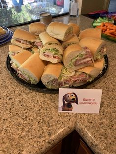 there are many sandwiches on the counter with a price tag in front of each one