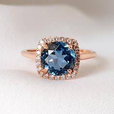 London Blue Topaz Engagement Ring, Blue Topaz Halo Ring, December Birthstone Ring, London Blue Topaz Ring Round Cut 8mmA round London Blue Topaz surrounded by 24 diamonds in a cushion shape halo. A really distinctive luxury ring, perfect choice for an engagement ring.__________________________________________Item  Details❤ Made to Order✔ Available Gold Color: Rose Gold, Yellow Gold, White Gold✔ Number of Blue Topaz: 1, Diameter 8mm, total CTW:2.85 Ctw✔ Number of Diamonds: 24, total CTW: 0.17 Ctw Blue Topaz Halo Ring, London Blue Topaz Engagement Ring, London Blue Topaz Engagement Rings, London Topaz Ring, Engagement Ring Blue, December Birthstone Ring, Blue Engagement Ring, Blue Topaz Engagement Ring, Amethyst Ring Engagement