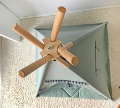 an upside down umbrella with wooden sticks sticking out of it