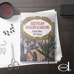 an australian cooking and baking book next to some scissors