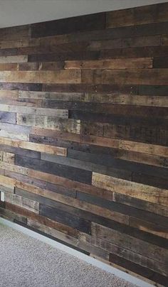 a wall made out of wooden planks in a room with carpeted flooring