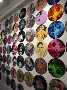 a wall covered with lots of different colored discs on it's sides and faces