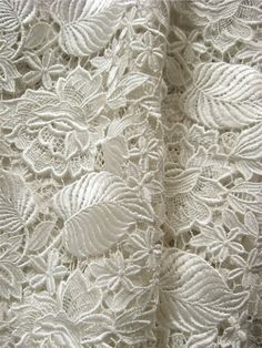 an image of white lace with leaves on it