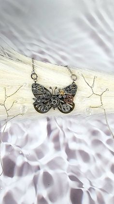 "✨️FREE SHIPPING (USPS First-Class Mail ONLY) and will ship out in ONE BUSINESS Day ✨️ Elevate Your Style with a Touch of Vintage Elegance Unveiling our mesmerizing Steampunk Butterfly Necklace, a masterpiece that transports you to an era of whimsical charm and mechanical marvels. Crafted with meticulous attention to detail, this one-of-a-kind necklace captures the essence of steampunk with its intricate gears, antique finishes, and dazzling crystal accents. At the heart of this piece lies a gra Handmade Black Steampunk Necklace, Vintage Handmade Butterfly Necklace, Adjustable Upcycled Necklace For Gift, Handmade Adjustable Steampunk Necklace, Adjustable Handmade Steampunk Necklaces, Handmade Butterfly Necklace For Festivals, Handmade Steampunk Jewelry For Festivals, Steampunk Butterfly, Jewellery Unique