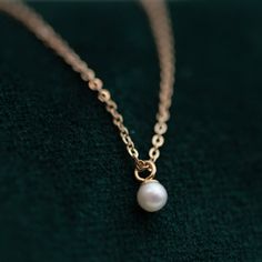 This Mini Pearl Pendant Necklace is the perfect complement for your evening wear or casual wardrobe. Crafted from 14k gold, this delicate necklace features a small cultured pearl, lending it a minimalist and elegant look. With this classic and versatile accessory, you're sure to make a statement. Pearl size: 2.75-3mm 1 Classic 14k Gold Necklace With Pearl Charm, Minimalist Akoya Pearl Necklace For Formal Occasions, Minimalist 14k Gold Pearl Pendant Necklace, Minimalist 14k Gold Pearl Necklace, Dainty Pearl Charm Necklace For Formal Occasions, Elegant Pearl Necklace With Round Pendant And Delicate Chain, Minimalist Akoya Pearl Pendant Necklace, Minimalist 14k Gold Pearl Necklace With Pearl Charm, Classic Pearl Necklace With Delicate Chain For Formal Occasions