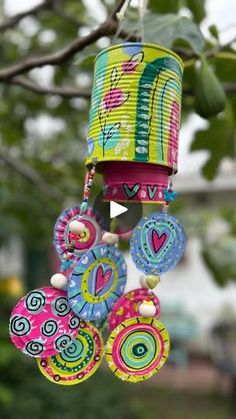 a colorful wind chime hanging from a tree