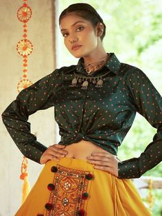 <ul>
<li style="text-align: justify;"><span data-preserver-spaces="true">Go for the sophisticated look with this classic mustard yellow color cotton fabric lehenga attached with Kutchi embroidered and mirror worked beautiful design with pom-pom tassels at the waist featured with layers at the bottom. </span></li>
<li style="text-align: justify;"><span data-preserver-spaces="true">Paired with green color gajji silk fabric long sleeve and shirt style Long Sleeve Traditional Wear With Cutdana For Navratri, Traditional Long Sleeve Wear With Cutdana For Navratri, Bohemian Long Sleeve Sharara With Pallu, Bohemian Sharara With Unstitched Blouse For Festive Occasions, Festive Bohemian Sharara With Unstitched Blouse, Green Kurta With Traditional Drape For Festival, Bohemian Sets With Unstitched Long Sleeve Blouse, Bollywood Style Bandhani Print Blouse Piece For Festive Occasions, Bohemian Sets With Unstitched Blouse And Long Sleeves