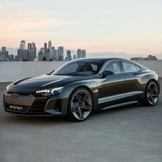 an electric car parked in front of a city skyline