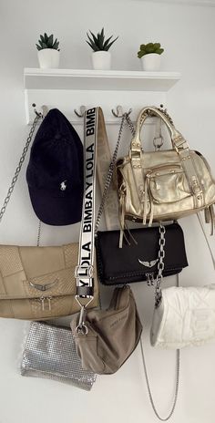 several purses and hats hanging on a wall