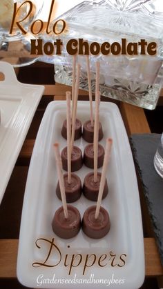 there are chocolate candies on a plate with toothpicks