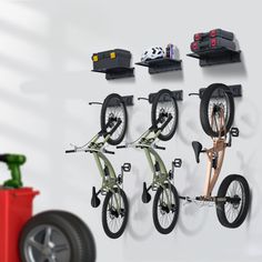 there is a bike hanging on the wall with three bikes attached to it's hooks