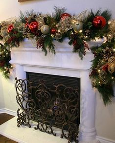 a fireplace decorated for christmas with garland and ornaments