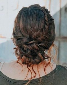 the back of a woman's head with her hair in a braid