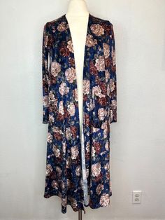 Name Brand: NWT LuLaRoe Sarah Duster Cardigan Velvet Blue Multicolor Floral Print Size S Condition: NWT Material: Polyester Blend Always check the measurements, label sizes are not consistent. Measurements are approximate, and are of item laying flat and unstreched: Shoulder to Shoulder: 13" Bust: 19" Sleeve: 22" Length: 42" (front, from shoulder to hem) Long Floral Print Cardigan For Fall, Blue Long Outerwear For Layering, One Size Floral Print Fall Cardigan, One Size Floral Print Cardigan For Fall, Long Blue Cardigan, Duster Cardigan, Blue Velvet, Label Sizes, Sweater Outfits