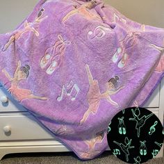 a purple blanket with ballet images on it